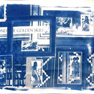 May include: A blue and white artwork featuring multiple framed images and the text "EVOND THE GOLDEN SKIES." The artwork has a vintage aesthetic, with a collage of images and patterns. The frames vary in size and style, creating a layered effect.