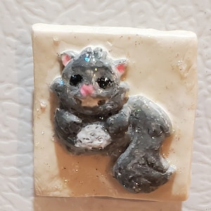 Refrigerator Magnet of A Dark Gray Phabrisaur Squirrel with A White Belly