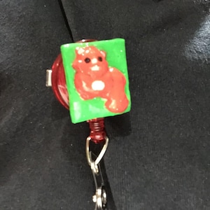 Badge Reel of A Red Squirrel with A Green Background, May 2025