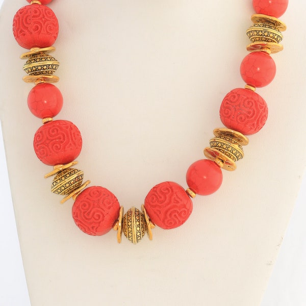 red cinnabar and crackle coral beads with gold toned spacers