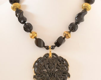 black and gold combination with large large black Chinese carved pendant with gold elctroplate encasing