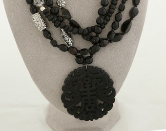 carved black jade pendant, 4 strands of asst. black jet beads