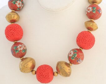 red necklace of cinnabar, cloisonne, and brass beads