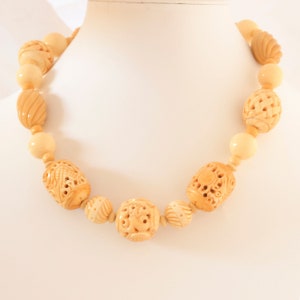 Single strand of carved bone and taqua nut beads