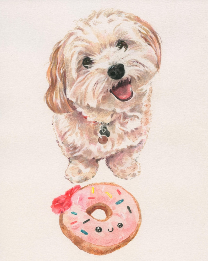 May include: A white fluffy dog with a pink tongue sticking out is looking up at the camera. The dog is sitting on a white background with a pink donut with colorful sprinkles and a happy face on it.