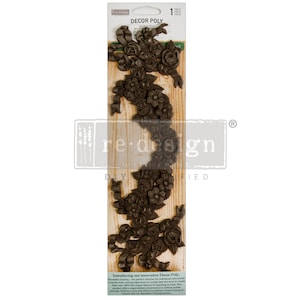 May include: A package of brown plastic moldings with a floral design. The package is labeled "Decor Poly" and "re-design withoprima".