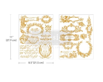 May include: A set of two gold-colored decorative transfer sheets, each measuring 8.5 inches (21.5 cm) wide and 11 inches (27.9 cm) tall. The sheets feature ornate frames, floral designs, and script text, with the word "NOUVEAU" visible.