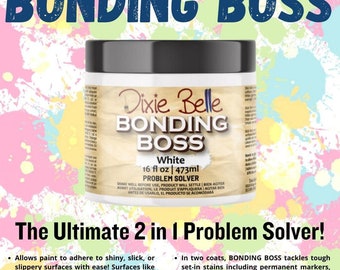May include: A white bottle of Dixie Belle Bonding Boss Problem Solver paint. The bottle is labeled with the product name, size (16 fl oz / 473 ml), and instructions for use. The bottle is sitting on a colorful background.