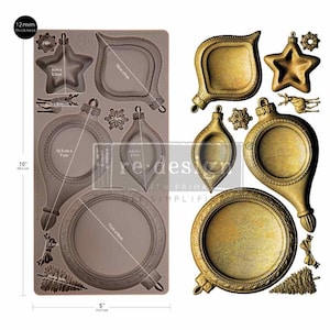 May include: A rectangular silicone mold with a 12mm thickness, 10-inch height, and 5-inch width, featuring cavities for various holiday ornaments. Beside it are the corresponding gold-colored cast shapes, including stars, baubles, a deer, and a tree.