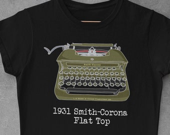 May include: Black t-shirt with a white graphic of a 1931 Smith-Corona Flat Top typewriter. The text "1931 Smith-Corona Flat Top" is printed below the typewriter.