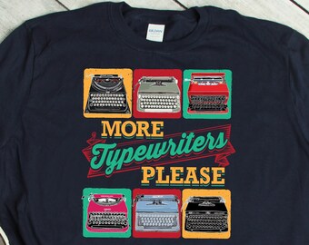 May include: A navy blue t-shirt with a graphic of vintage typewriters and the text "More Typewriters Please".