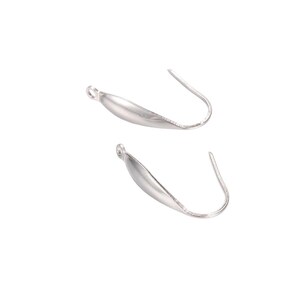 May include: Two silver-toned metal earring hooks with a smooth, curved, leaf-like decorative component attached to the front. Each piece features a small circular loop at the top for connecting jewelry elements and a curved wire for ear insertion.