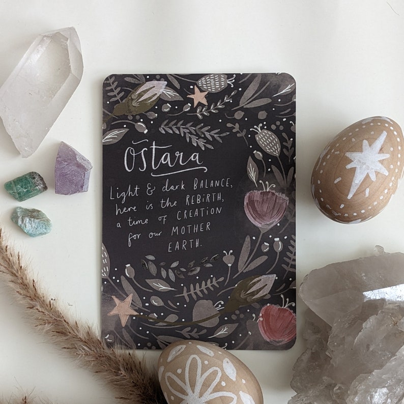 May include: A black card with a floral design and the text "Ostara Light & dark BALANCE, here is the REBIRTH, a time of CREATION for our MOTHER EARTH."