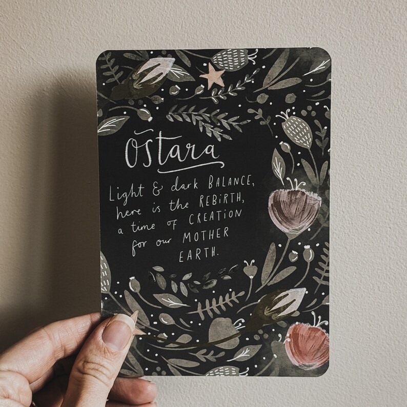 May include: A black card with floral illustrations and the text "Ostara Light & dark BALANCE, here is the REBIRTH, a time of CREATION for our MOTHER EARTH."