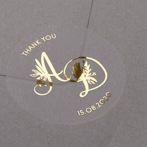 Foiled Thank you wedding stickers with personalised initials and date. Gold, rose gold and silver foil print on semi clear matt sticker.