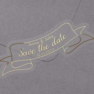 Save the date Foiled Wedding stickers. Personalised labels with names and date. Gold foil sticker for envelopes on semi clear label.