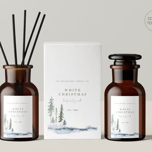 May include: Two amber glass apothecary bottles and a white rectangular candle box. One bottle contains black reed diffuser sticks. All items feature white labels with a watercolour pine tree forest graphic and the text White Christmas.