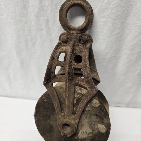 Antique primitive metal pulley with wooden wheel, rustic interior, Vintage decor
