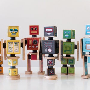 May include: Six colorful wooden robot toys with different facial expressions and designs. Each robot is made of multiple blocks that can be stacked and rearranged.