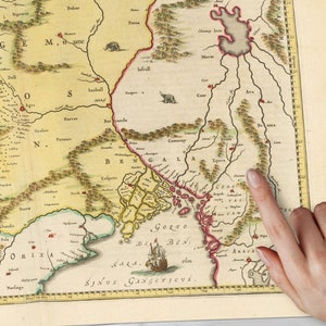 May include: An antique map of the Bengal region of India, showing the Bay of Bengal, the Ganges River, and surrounding areas. The map is hand-drawn and features intricate details, including mountains, rivers, and cities. The map is printed on paper and has a yellowed, aged appearance.