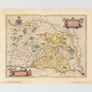 Puede incluir: Un mapa antiguo de la región de Dombes en Francia, que presenta una ilustración detallada de la geografía y las ciudades de la región. El mapa está rodeado por un borde decorativo con un escudo de armas y querubines.