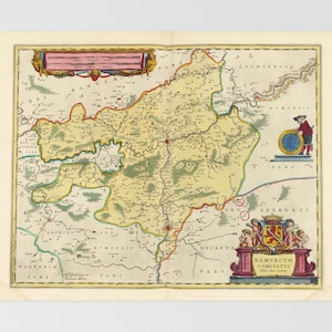 May include: A vintage map of a region, featuring detailed cartography with various colors. The map includes text in Latin, a decorative cartouche with a coat of arms, and a figure with a globe. The map is on aged paper.