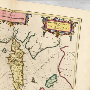 May include: An antique map of "Buthe Insula, Vulgo The Yle of Boot" with a detailed illustration of the island and surrounding waters. The map is printed on aged paper with a yellowed tint and features a decorative border with ornate details.