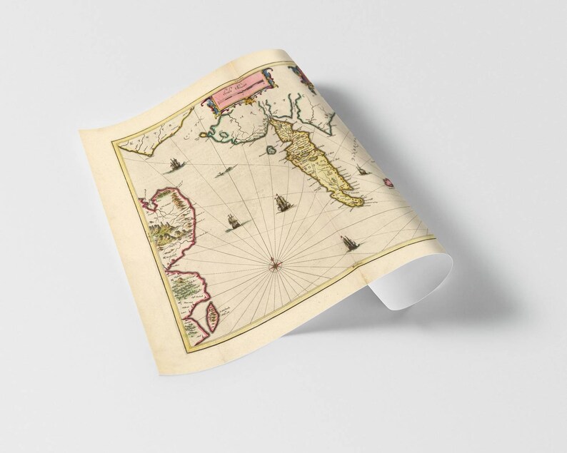 May include: An antique map of the coast of the island of Crete, printed in brown, green, and yellow ink on a cream-colored background. The map is titled "Creta Insula" and includes a compass rose and several ships.