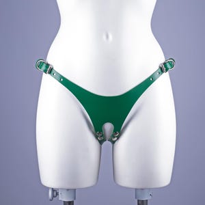 May include: Green leather underwear with a cutout and metal accents.