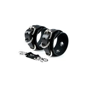 May include: Black leather wrist cuffs with silver buckles and a matching key chain.