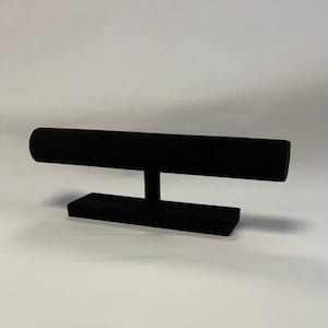 May include: Black velvet jewellery display stand with a round rod for bracelets or bangles.