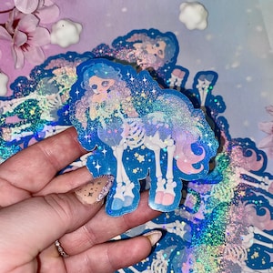 May include: A holographic sticker featuring a cartoon skeleton horse with a pastel blue, pink, and purple color scheme. The horse has a human-like face and is adorned with stars and glitter.