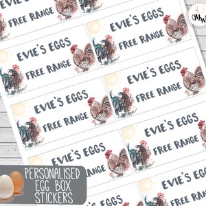 May include: A sheet of personalised egg box stickers. Each sticker has the text "Evie's Eggs Free Range" with a watercolour illustration of a rooster and a sun. The stickers are white with grey text.