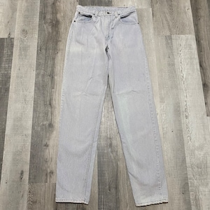 May include: Light gray denim jeans with a straight leg fit.