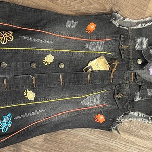 Hand painted floral jean vest, with new tags, and is brand new and never worn, in size medium. It had a lot of detailed work added to it.