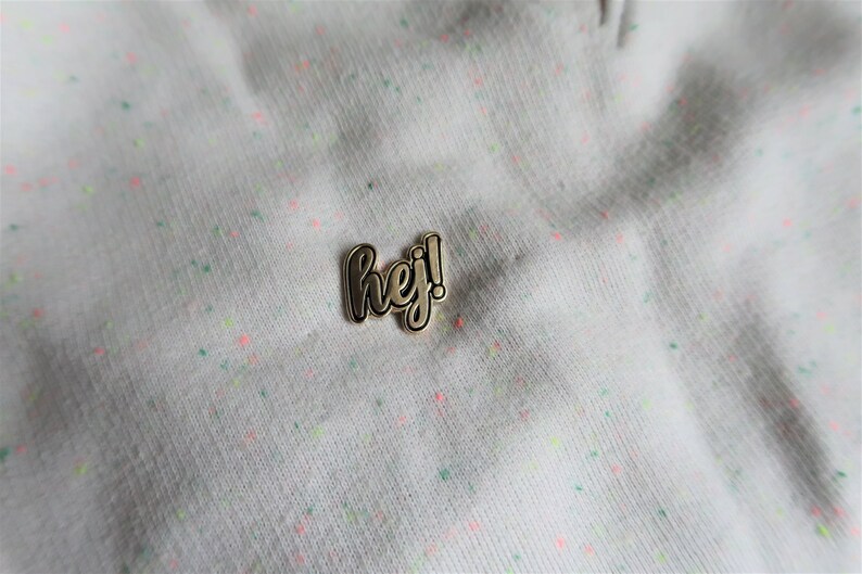 Hej in black Sweden inspired enamel pin