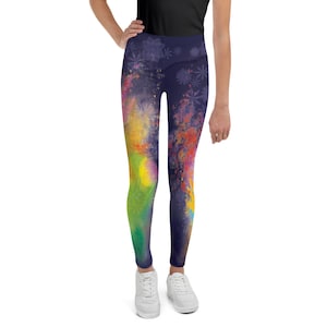 May include: A pair of black leggings with a colourful abstract print. The print features splashes of yellow, green, pink, and blue on a dark background.