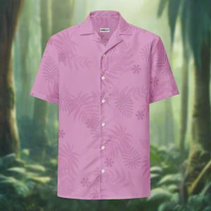 May include: A short-sleeved, button-down shirt in a light pink color. The shirt features a subtle, repeating pattern of leaves and flowers. The collar is open, and the shirt has a relaxed fit, suitable for warm weather.