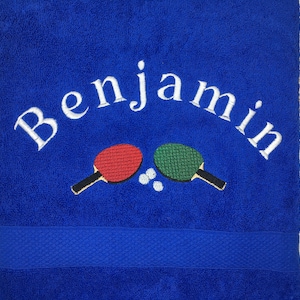 May include: Blue towel with white embroidery that says "Benjamin" and two embroidered ping pong paddles with a white ball in between.