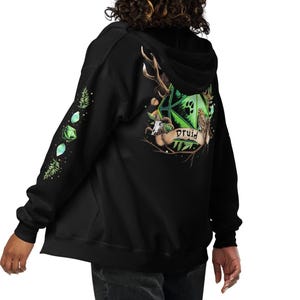 May include: Black zip-up hoodie with a green and white graphic on the back featuring a D20 die, antlers, and the word "Druid". The left sleeve has green gem and plant graphics. The hoodie is made of a soft material.
