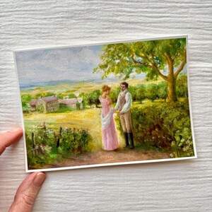 Puede incluir: Impresi&oacute;n de pintura al &oacute;leo que representa a una pareja con vestimenta de &eacute;poca en un camino. La mujer lleva un vestido rosa, y el hombre un chaleco y pantalones. El fondo muestra un paisaje con un &aacute;rbol, campos y una casa.