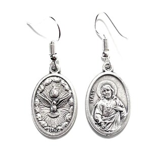 May include: Silver-toned oval earrings. One earring features a dove with rays, the word "Italy" at the bottom. The other earring depicts a religious figure with the word "Italy" on the side. Both earrings have a hook closure.