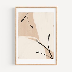May include: Abstract art print with black brushstrokes on a beige and white background. The print is framed in a light wood frame.