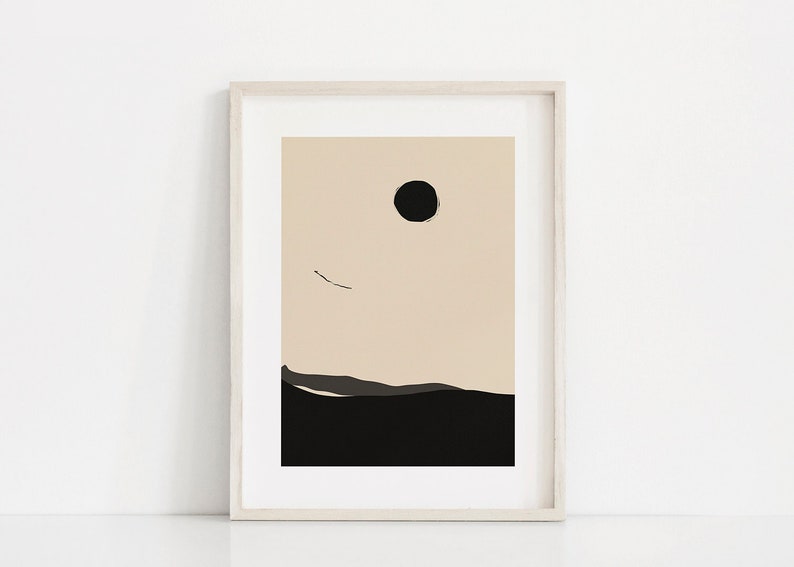 May include: A framed abstract print with a black circle and a thin black line against a beige background. The bottom of the print is black with a dark gray line.
