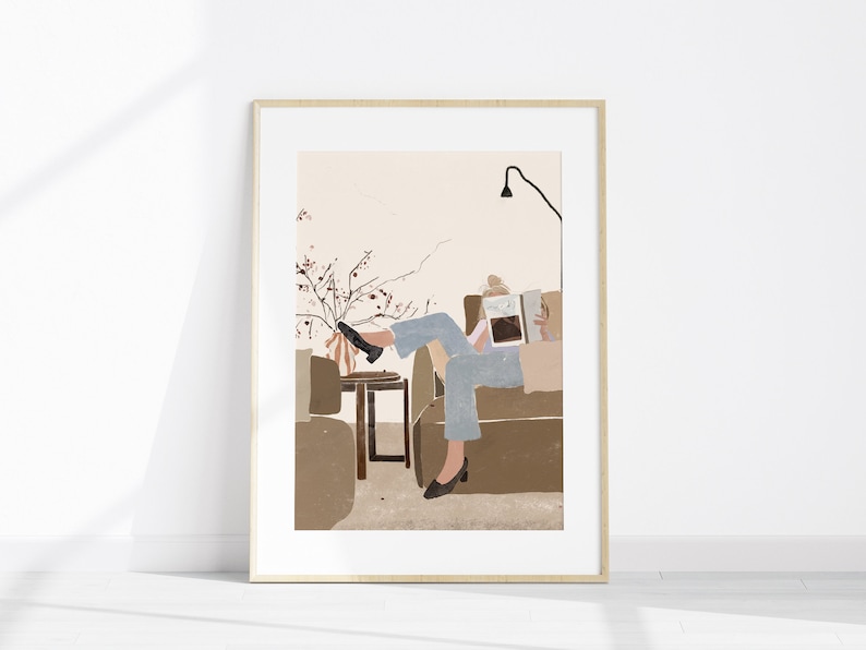 May include: A digital illustration of a person sitting on a couch, reading a book. The person is wearing blue jeans and a white shirt. The couch is brown and there is a small table next to it. There is a plant with pink flowers in the background.