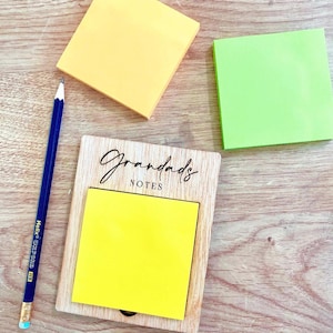 May include: A wooden note holder with the text "Grandads Notes" engraved on the front. A yellow sticky note is attached to the holder.