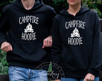 May include: Two black hoodies with white text and a campfire graphic. The text on the hoodies reads "Campfire Hoodie".