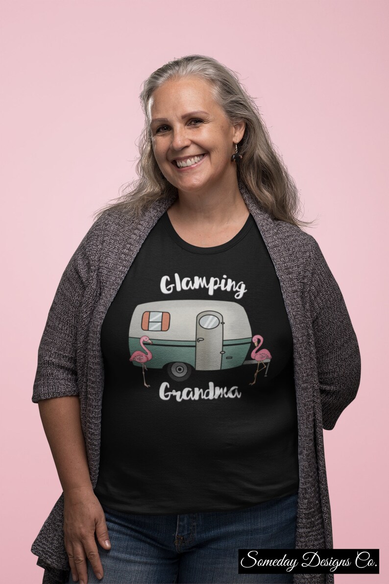 May include: Black t-shirt with a white camper van graphic and the text "Glamping Grandma" with two pink flamingos on either side of the camper. The text "Someday Designs Co." is at the bottom of the shirt.