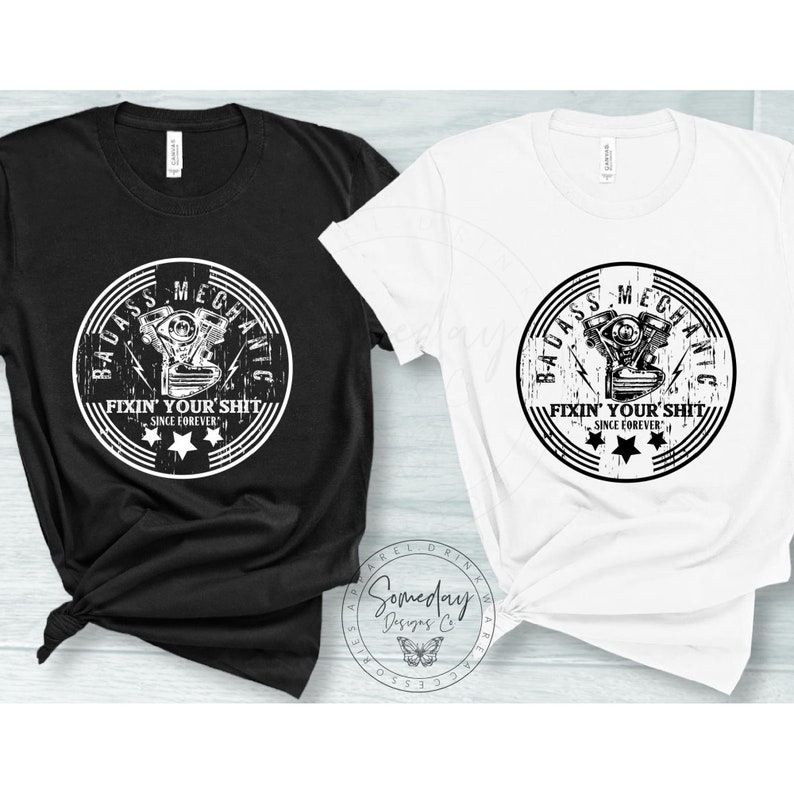 May include: Two t-shirts with a distressed white graphic of a motorcycle engine with the text "Badass Mechanic Fixin' Your Shit Since Forever" in a circle.