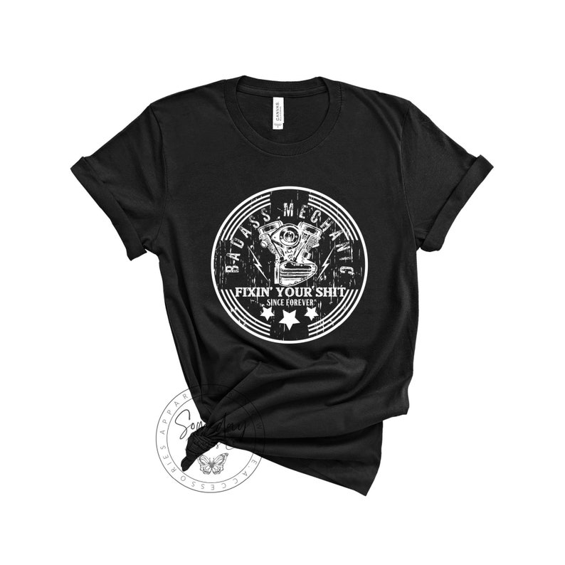 May include: Black t-shirt with a white graphic of a motorcycle engine and the text "Badass Mechanic Fixin' Your Shit Since Forever".
